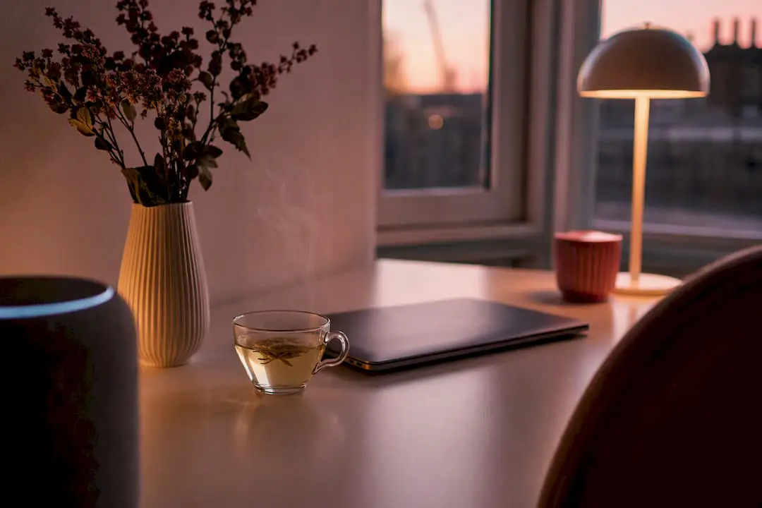 Desk with smart speaker symbolizing AI helpdesk